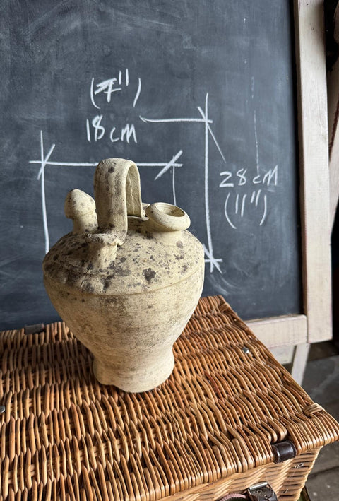 A rustic original Chartreuse cream ceramic pitcher with a curved handle and spout with dimensions.
